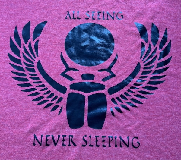 Red t-shirt with black All Seeing, Never Sleeping scarab logo